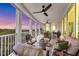A spacious, covered balcony featuring comfortable seating and stunning views of the surrounding landscape and water at 401 N Point Rd # 504, Osprey, FL 34229