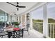 Covered balcony features a table and chairs, perfect for enjoying outdoor meals and the surrounding scenery at 401 N Point Rd # 504, Osprey, FL 34229
