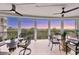 A beautiful enclosed balcony with amazing views, ceiling fans, and outdoor furniture for relaxing at 401 N Point Rd # 504, Osprey, FL 34229