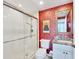 Bathroom with red patterned wallpaper, shower and sink with granite countertops at 401 N Point Rd # 504, Osprey, FL 34229