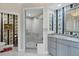 Bathroom features a walk-in shower, granite countertops, decorative wallpaper, and a stylish mirror at 401 N Point Rd # 504, Osprey, FL 34229