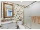 Bathroom with floral wallpaper, shower and sink with marble countertops at 401 N Point Rd # 504, Osprey, FL 34229
