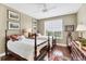 Bedroom featuring hardwood floors, twin beds, and shutters for natural light creating a warm and inviting space at 401 N Point Rd # 504, Osprey, FL 34229