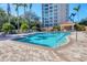 Resort-style community pool with plenty of seating and lush landscaping offers a relaxing oasis for residents at 401 N Point Rd # 504, Osprey, FL 34229