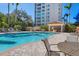 Inviting community pool with lounge chairs, tables, and a shaded pavilion for relaxation and enjoyment at 401 N Point Rd # 504, Osprey, FL 34229