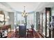 Dining room with a glass table, hardwood floors, and a display cabinet at 401 N Point Rd # 504, Osprey, FL 34229