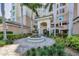 Inviting condominium entrance with water feature, lovely landscaping, and well-maintained facade at 401 N Point Rd # 504, Osprey, FL 34229