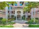 Elegant condo entrance featuring a fountain, lush landscaping and covered entry way at 401 N Point Rd # 504, Osprey, FL 34229