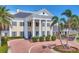 Elegant exterior with columns, circular driveway, and lush landscaping at 401 N Point Rd # 504, Osprey, FL 34229