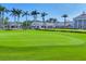 Expansive green lawn dotted with palm trees enhances the beauty of this luxurious home at 401 N Point Rd # 504, Osprey, FL 34229