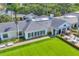 Stunning home exterior featuring lush green lawn, manicured landscaping, and outdoor seating area perfect for entertaining at 401 N Point Rd # 504, Osprey, FL 34229