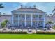 Elegant clubhouse features large columns, outdoor seating and expansive green space at 401 N Point Rd # 504, Osprey, FL 34229