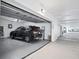 Garage with car parked inside and garage door opening mechanism at 401 N Point Rd # 504, Osprey, FL 34229