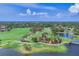 Aerial view of the expansive golf course with lush greenery, water features, and manicured landscapes on a sunny day at 401 N Point Rd # 504, Osprey, FL 34229