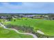 Expansive golf course view with lush green fairways, sand traps, manicured greens, and a beautiful clubhouse in the background at 401 N Point Rd # 504, Osprey, FL 34229