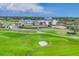 Beautiful golf course view with clubhouse, manicured green, and sand trap on a sunny day at 401 N Point Rd # 504, Osprey, FL 34229