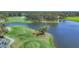 Golf course view with a tree island in the middle of a lake, with lush green fairways and manicured grounds at 401 N Point Rd # 504, Osprey, FL 34229