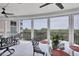 Enclosed lanai featuring tile flooring, ceiling fans, and panoramic views at 401 N Point Rd # 504, Osprey, FL 34229