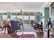 Bright and open living room with hardwood floors, large windows, and access to a balcony at 401 N Point Rd # 504, Osprey, FL 34229