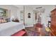 Cozy main bedroom with a four-poster bed, hardwood floors, and classic decor, offering a relaxing retreat at 401 N Point Rd # 504, Osprey, FL 34229