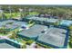 Aerial view of several outdoor tennis courts with lush greenery and tall netting at 401 N Point Rd # 504, Osprey, FL 34229