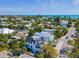 Aerial view of a beautiful neighborhood with palm trees and a luxurious beach house, highlighting the coastal scenery at 421 Alamanda Rd, Anna Maria, FL 34216