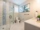Bathroom with a glass-enclosed shower and mosaic tile accents at 421 Alamanda Rd, Anna Maria, FL 34216