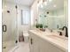 Bright bathroom with double vanity, modern fixtures, and a glass-enclosed shower at 421 Alamanda Rd, Anna Maria, FL 34216