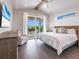 Bedroom boasts a king bed and sliding doors to a private patio at 421 Alamanda Rd, Anna Maria, FL 34216