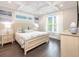 Serene bedroom with coffered ceilings, hardwood floors, and plenty of natural light at 421 Alamanda Rd, Anna Maria, FL 34216