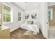 Bright bedroom with white shiplap walls, hardwood floors, and a daybed for flexible living at 421 Alamanda Rd, Anna Maria, FL 34216