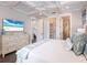 Spacious bedroom featuring a coffered ceiling, ensuite bathroom access, and hardwood floors at 421 Alamanda Rd, Anna Maria, FL 34216