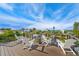 Spacious rooftop deck with comfortable white Adirondack seating, offering scenic neighborhood and water views at 421 Alamanda Rd, Anna Maria, FL 34216