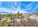 Relaxing rooftop deck with multiple chairs overlooking the neighborhood, water, and lush greenery at 421 Alamanda Rd, Anna Maria, FL 34216