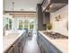 Modern gray kitchen featuring stainless steel appliances, a white countertop, and view to dining room at 421 Alamanda Rd, Anna Maria, FL 34216