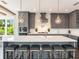 Stylish gray kitchen featuring a large island with bar stool seating and modern light fixtures at 421 Alamanda Rd, Anna Maria, FL 34216