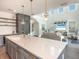 Spacious kitchen with an island, gray cabinets, stainless steel appliances, and modern pendant lights at 421 Alamanda Rd, Anna Maria, FL 34216