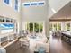 Living area with high ceilings, a built-in entertainment center, and access to the outside patio at 421 Alamanda Rd, Anna Maria, FL 34216