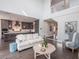 Open-concept living space with a white couch, kitchen island, and a view of the staircase at 421 Alamanda Rd, Anna Maria, FL 34216
