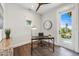 Bright office space with natural light, featuring dark wood floors, modern desk, and access to outdoor balcony at 421 Alamanda Rd, Anna Maria, FL 34216