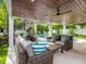 Spacious outdoor living area featuring cozy seating, a view of the pool and lush landscaping at 421 Alamanda Rd, Anna Maria, FL 34216