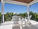 Covered patio with two Adirondack chairs and a table at 421 Alamanda Rd, Anna Maria, FL 34216