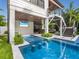 Backyard pool featuring a swim-up bar and outdoor living space with a TV for ultimate relaxation and entertainment at 421 Alamanda Rd, Anna Maria, FL 34216