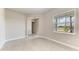 Bedroom with white trim and a big window that looks out onto a green landscape at 4210 Sea Marsh Pl, Parrish, FL 34219