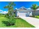 Inviting curb appeal with a well-maintained lawn, complemented by beautiful landscaping and a two-car garage at 4210 Sea Marsh Pl, Parrish, FL 34219
