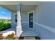 Cozy front porch featuring a support column, a view of the neighborhood, and a stylish front door at 4210 Sea Marsh Pl, Parrish, FL 34219