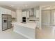 Elegant kitchen with a central island, stainless steel appliances, and white cabinets for a modern design at 4210 Sea Marsh Pl, Parrish, FL 34219