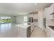 Modern open-concept kitchen featuring stainless steel appliances, a spacious island, and a view of the living area at 4210 Sea Marsh Pl, Parrish, FL 34219