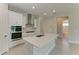 Bright kitchen showcasing stainless steel appliances, a center island, and a clean, modern design at 4210 Sea Marsh Pl, Parrish, FL 34219
