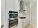 Modern kitchen featuring stainless steel appliances, stylish backsplash, and white cabinetry at 4210 Sea Marsh Pl, Parrish, FL 34219